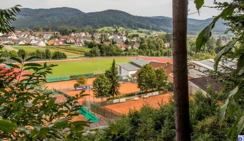 orangene Sandplätze zum Tennis spielen, im Hintergrund Neubaugebiet Ottersgraben 